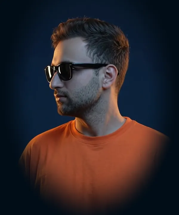 Muhammad Rehan in an orange t-shirt and dark glasses, turning to face the camera